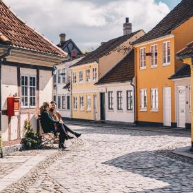 Women sitting on a bench in old town of Odense on Fyn